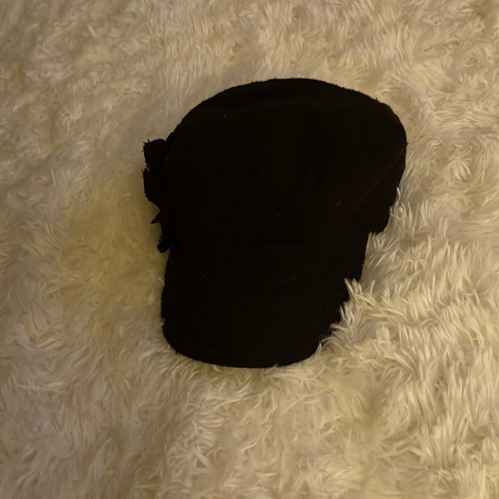 Black hat with elastic backing, fits most!  Cute flower on the side!